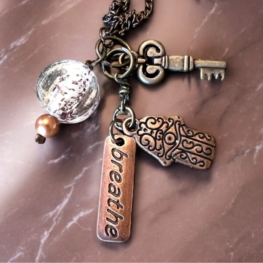 Unique bronze necklace key and charm details clear glass bead and 'breathe' tag. - Picture 13 of 15
